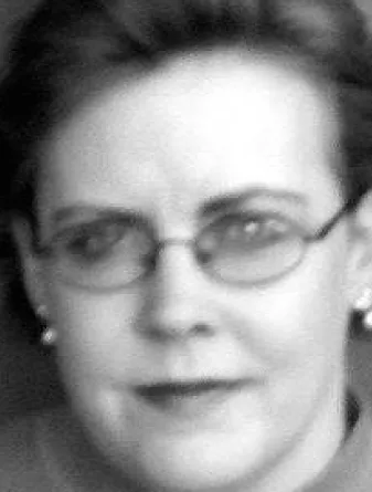 Julie Sandland smiling confidently at camera.