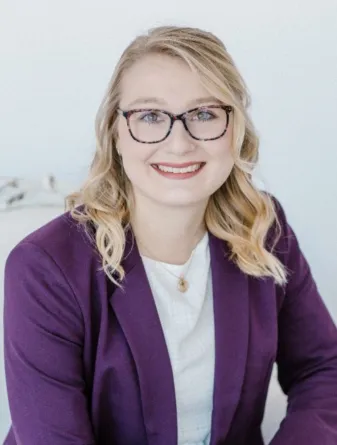 Lind smiling confidently at camera.