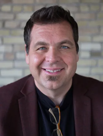 Strand smiling confidently at camera