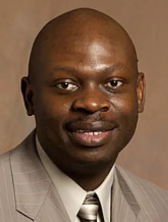 Peter Oduor smiling confidently at the camera