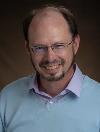 Littmann smiling confidently at camera