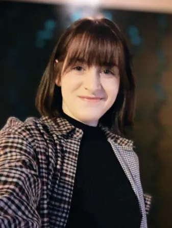 Alexandra looking confidently at camera.