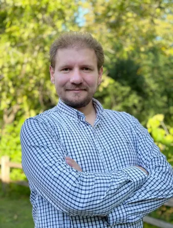 Dr. Yunus Emre Orhan smiling confidently at camera.