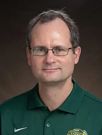 May smiling confidently at camera