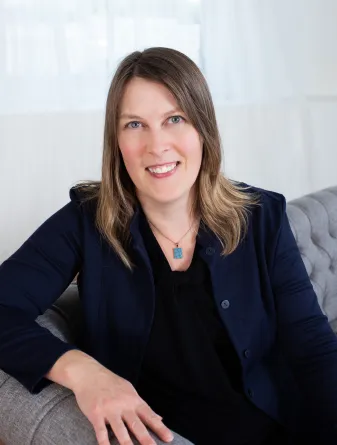 Deirdre Prischmann-Voldseth smiling confidently at camera.