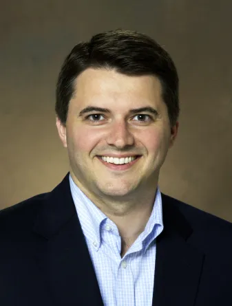 Benton smiling confidently at camera