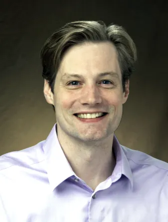 Andrew Stark smiling confidently at the camera