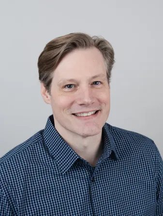 Andrew Stark smiling confidently at the camera