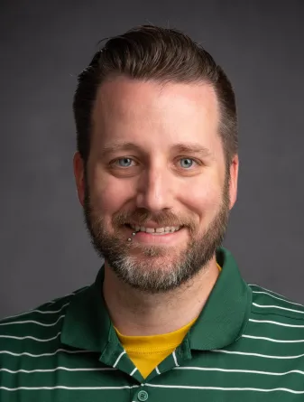 Travis Seaborn, PhD smiling confidently at camera.