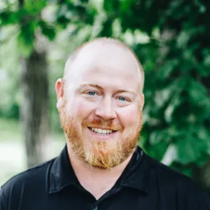 A man with a beard smiles