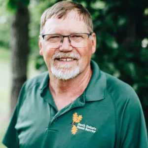 A man with glasses and a goatee smiles