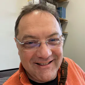 Angel Ugrinov smiling confidently at the camera