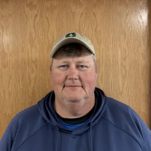 Headshot of a man in a hoodie and baseball cap