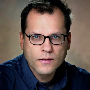 Uwe Burghaus smiling confidently at the camera