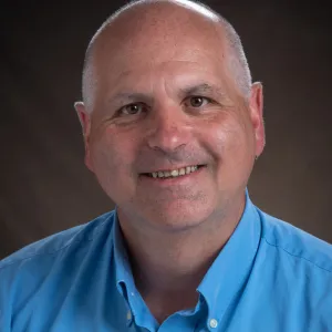 Greg Cook smiling confidently at camera