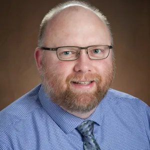 Stuart Haring smiling confidently at the camera