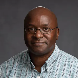 Nyachwaya smiling confidently at camera