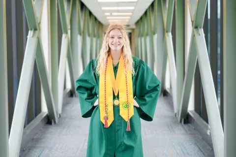 Dietz smiling in commencement gown