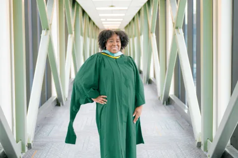 Jones smiling in commencement outfit