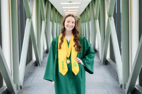 Niemiller smiling in commencement gown