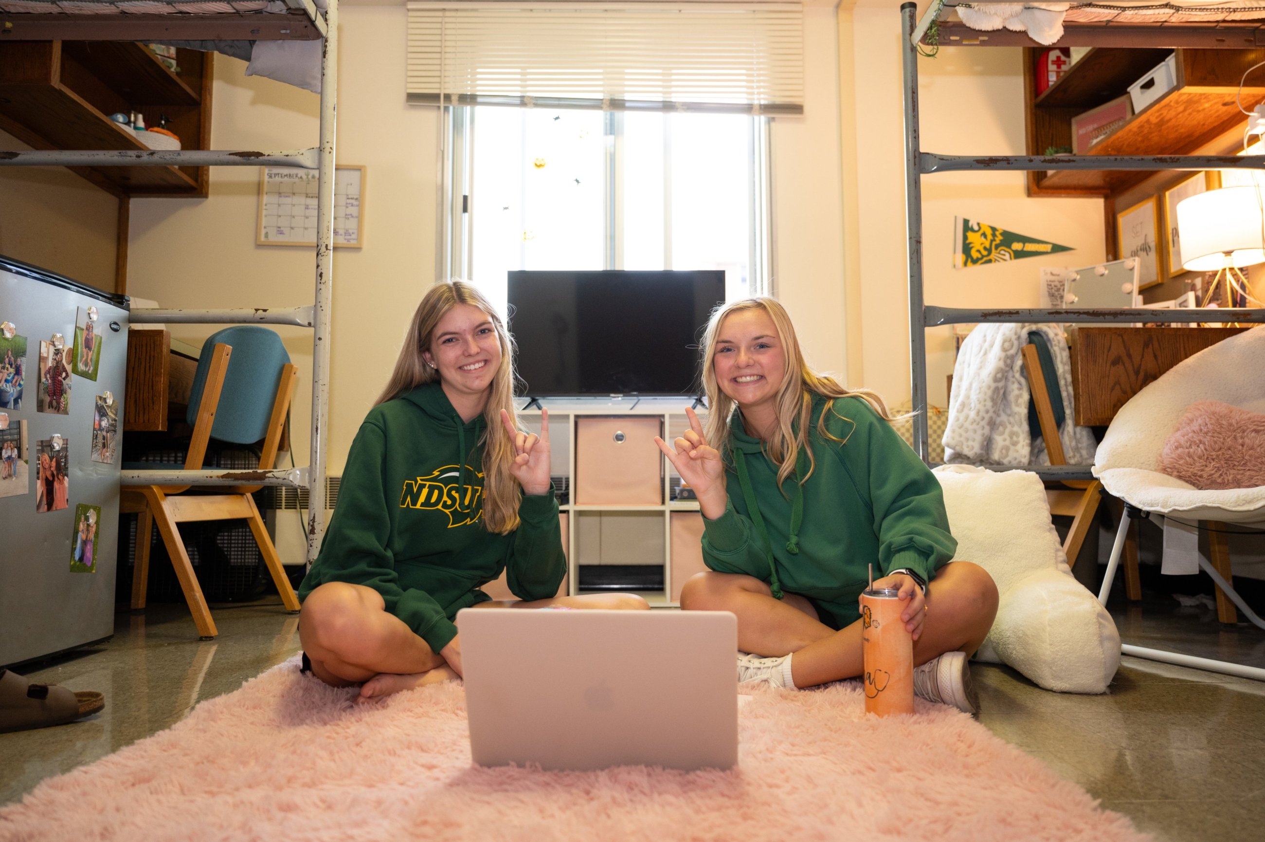 A photo of students in a residence hall room.