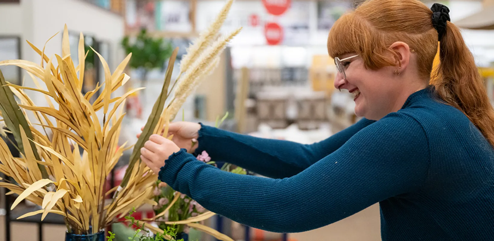 an NDSU student works on a flower arrangement as part of a project