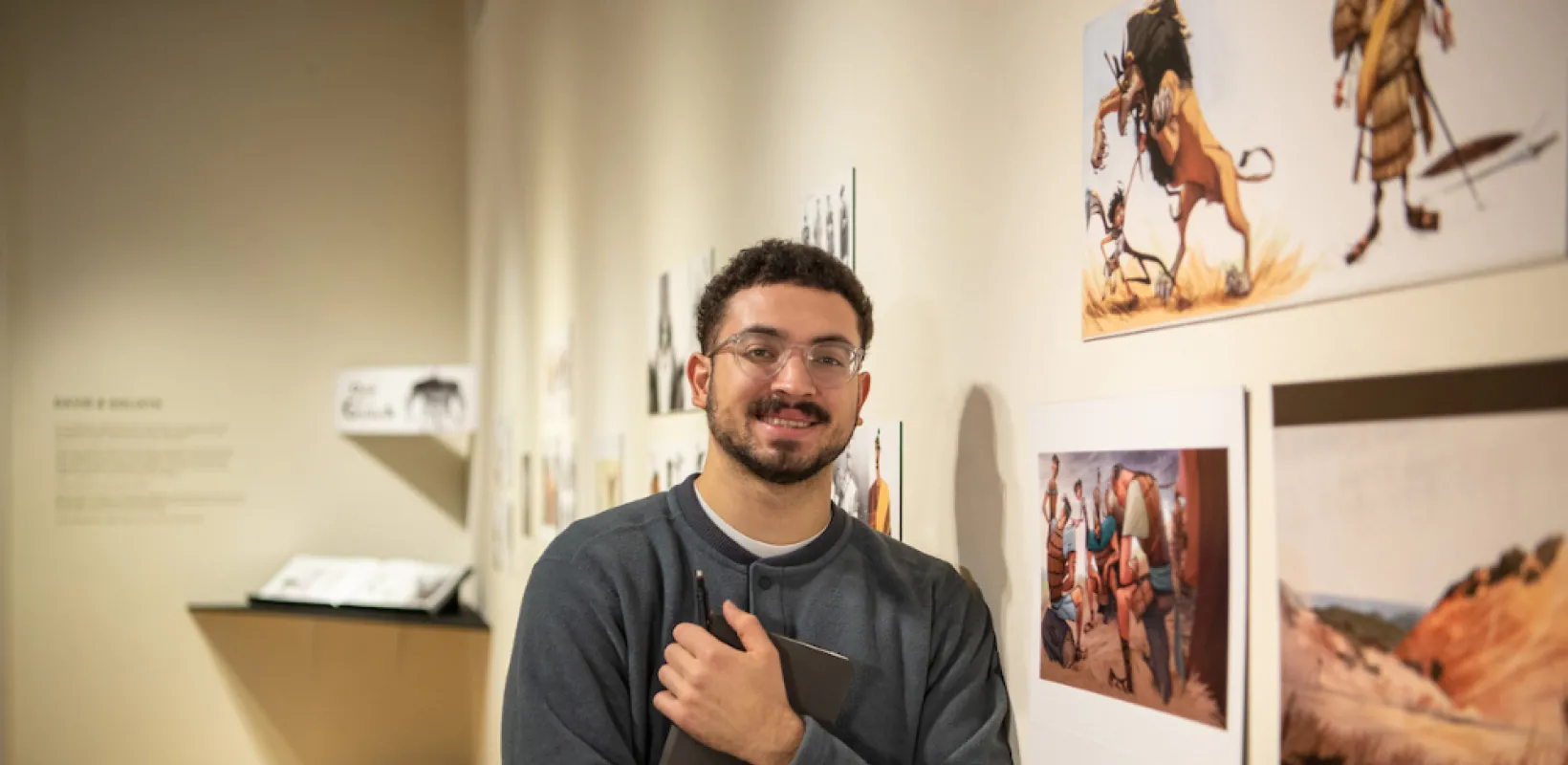 NDSU graduate standing in an art gallery