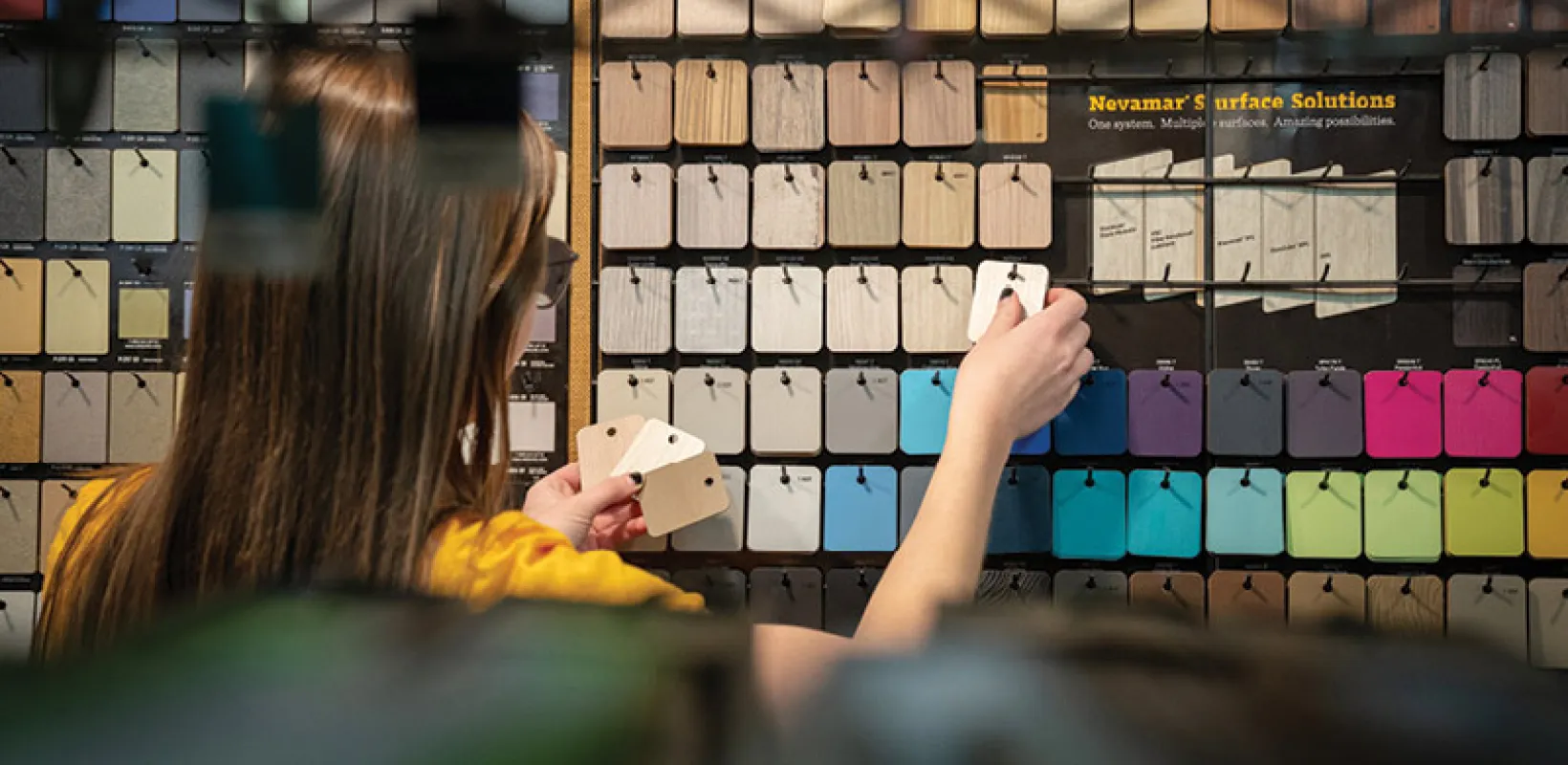 Student working with color samples in design studio.