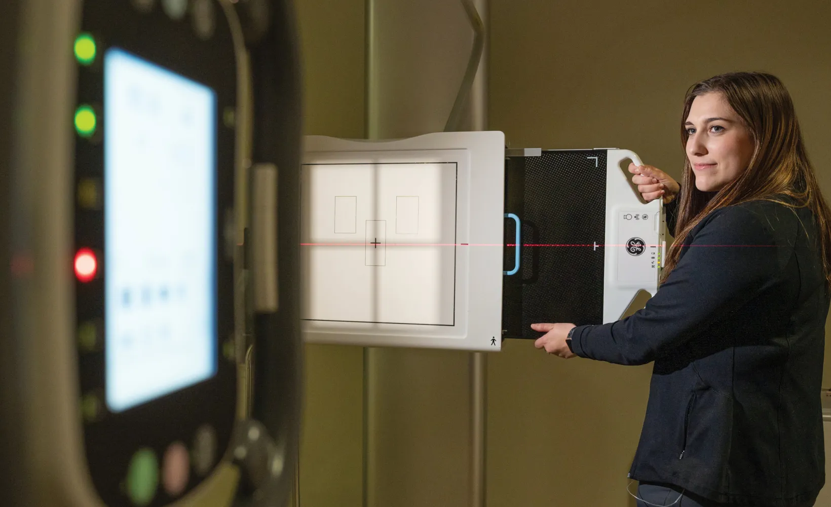 Radiology student setting up an X-ray.