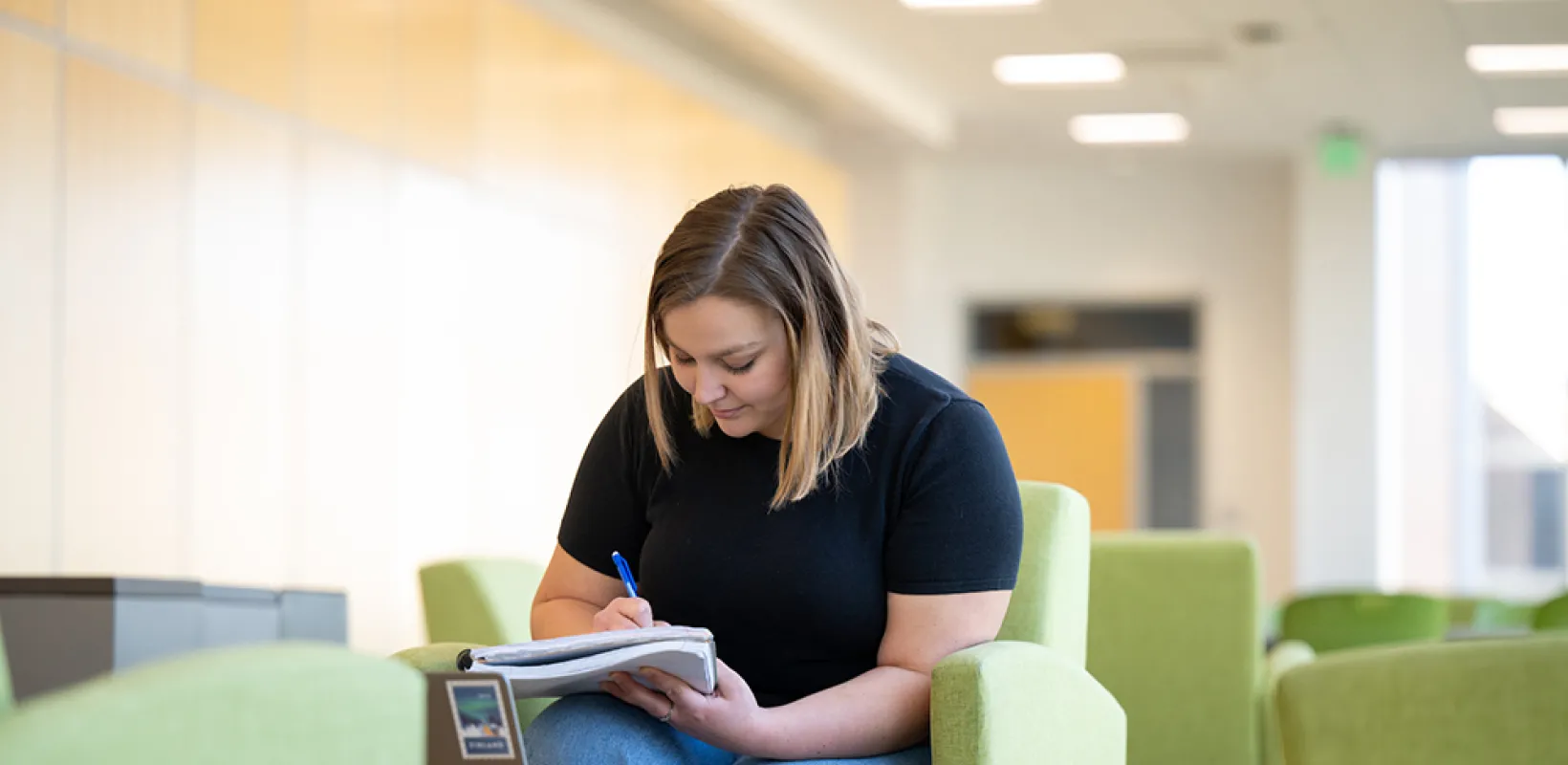 Grace Schmidt writing in notebook