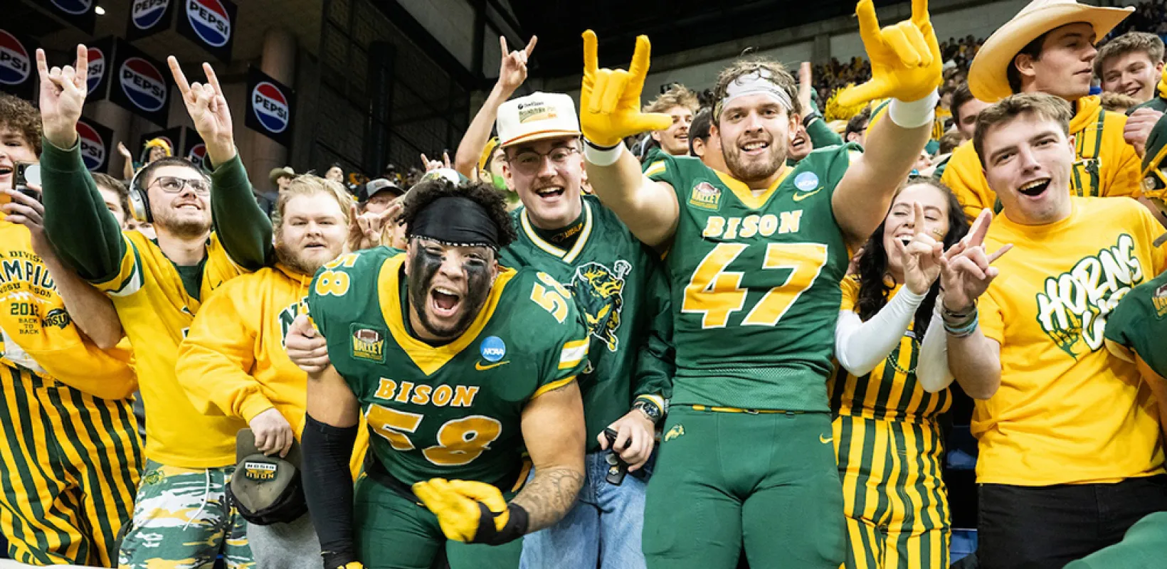 bison football players celebrating with fans
