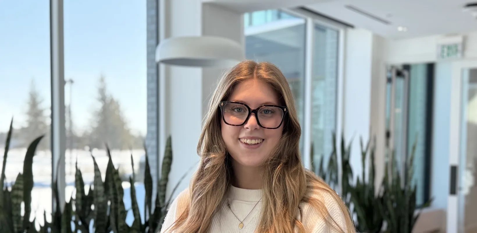 student standing in front of windows