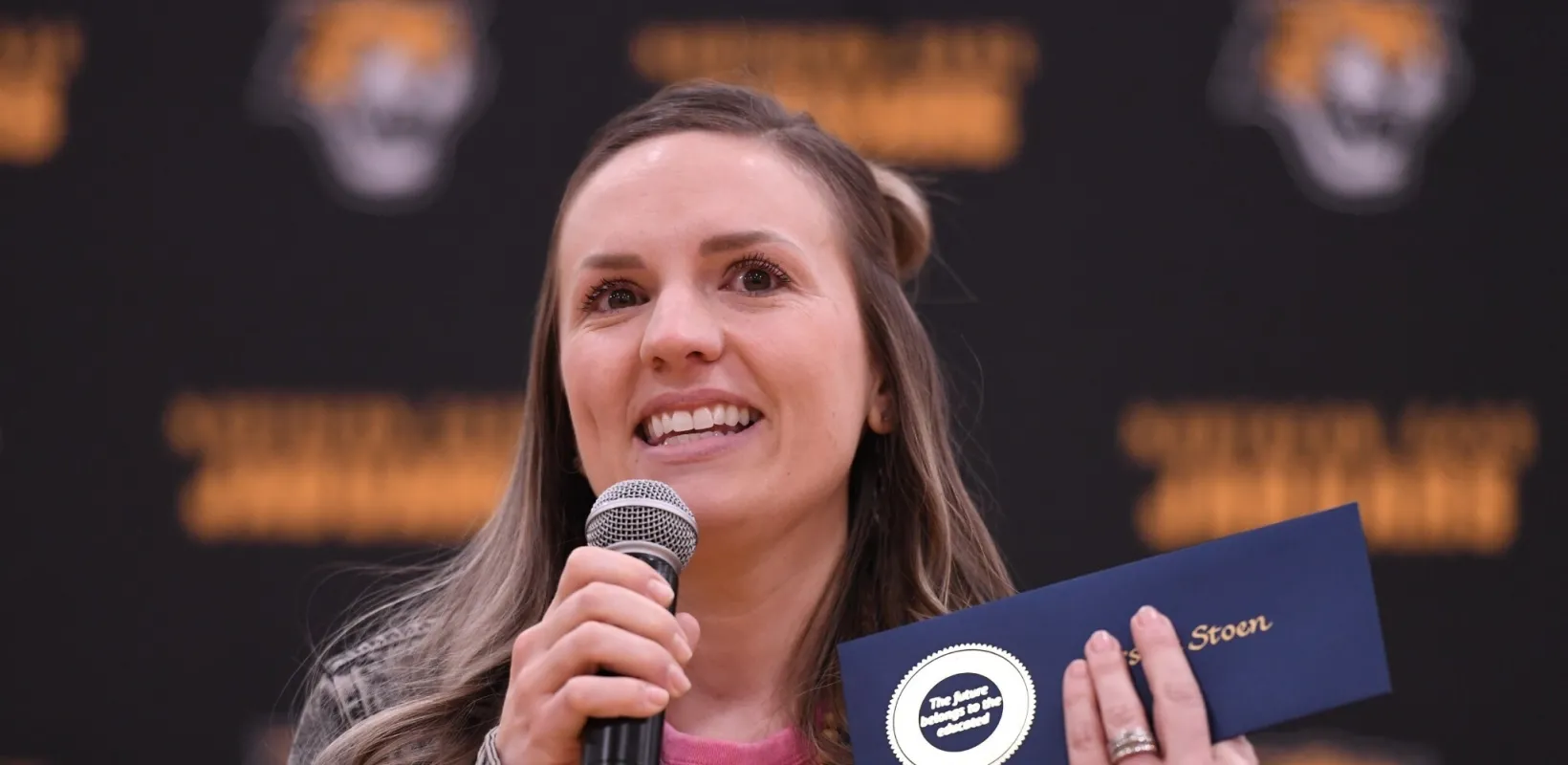 woman speaking into a microphone
