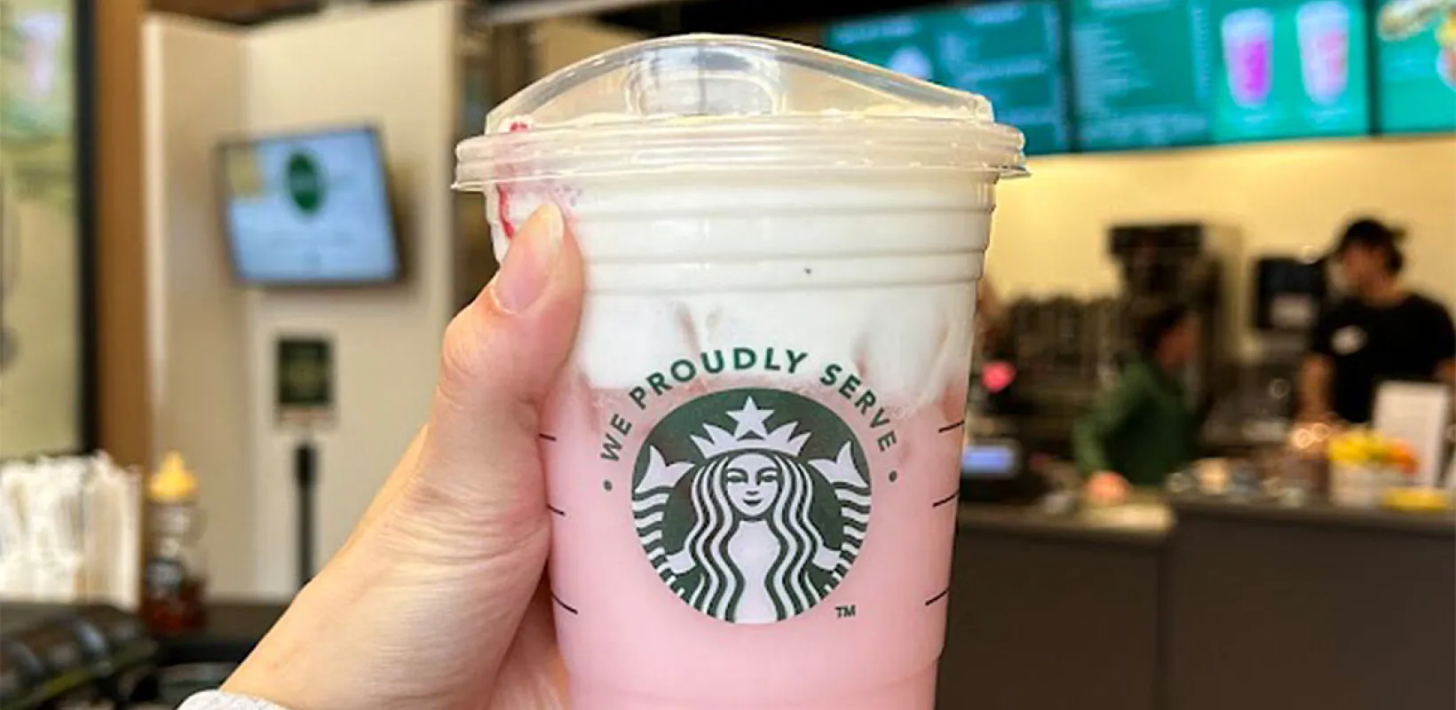 Student holding a Starbucks drink available at Minard Coffee Shop