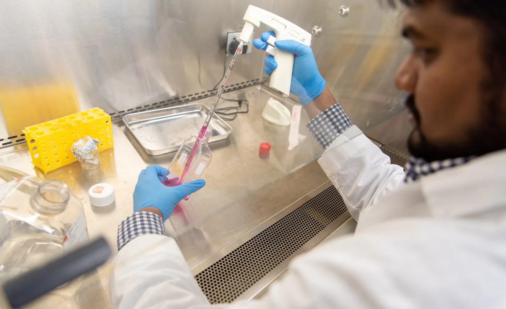Industrial and Manufacturing Engineering student performing an experiment in a lab