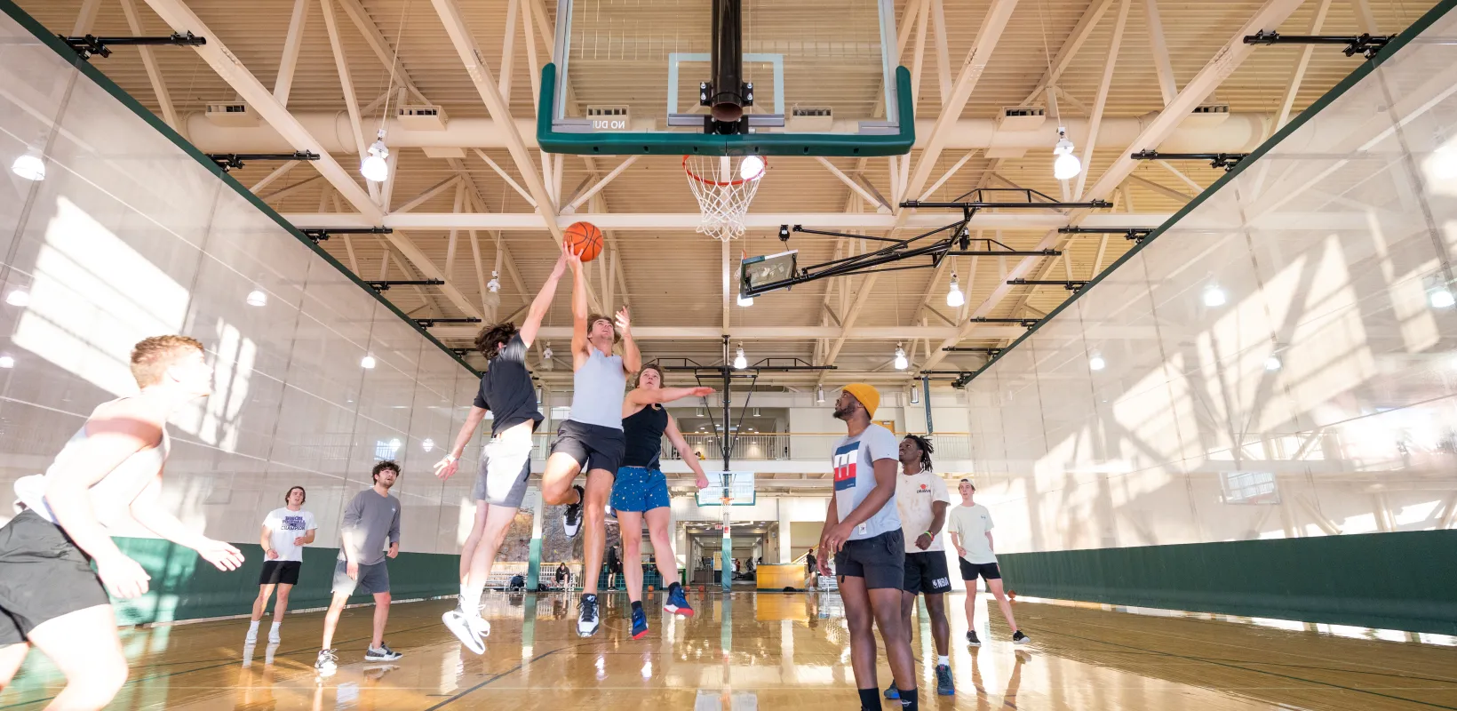 Male students playing pick up basketball game at NDSU Wellness Center