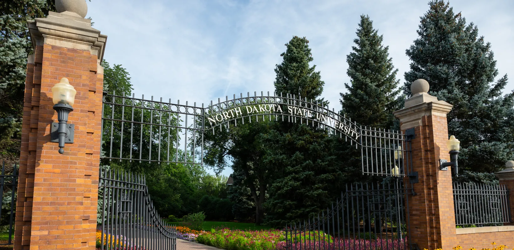 View of NDSU East Entrance Gate with blooming flowers
