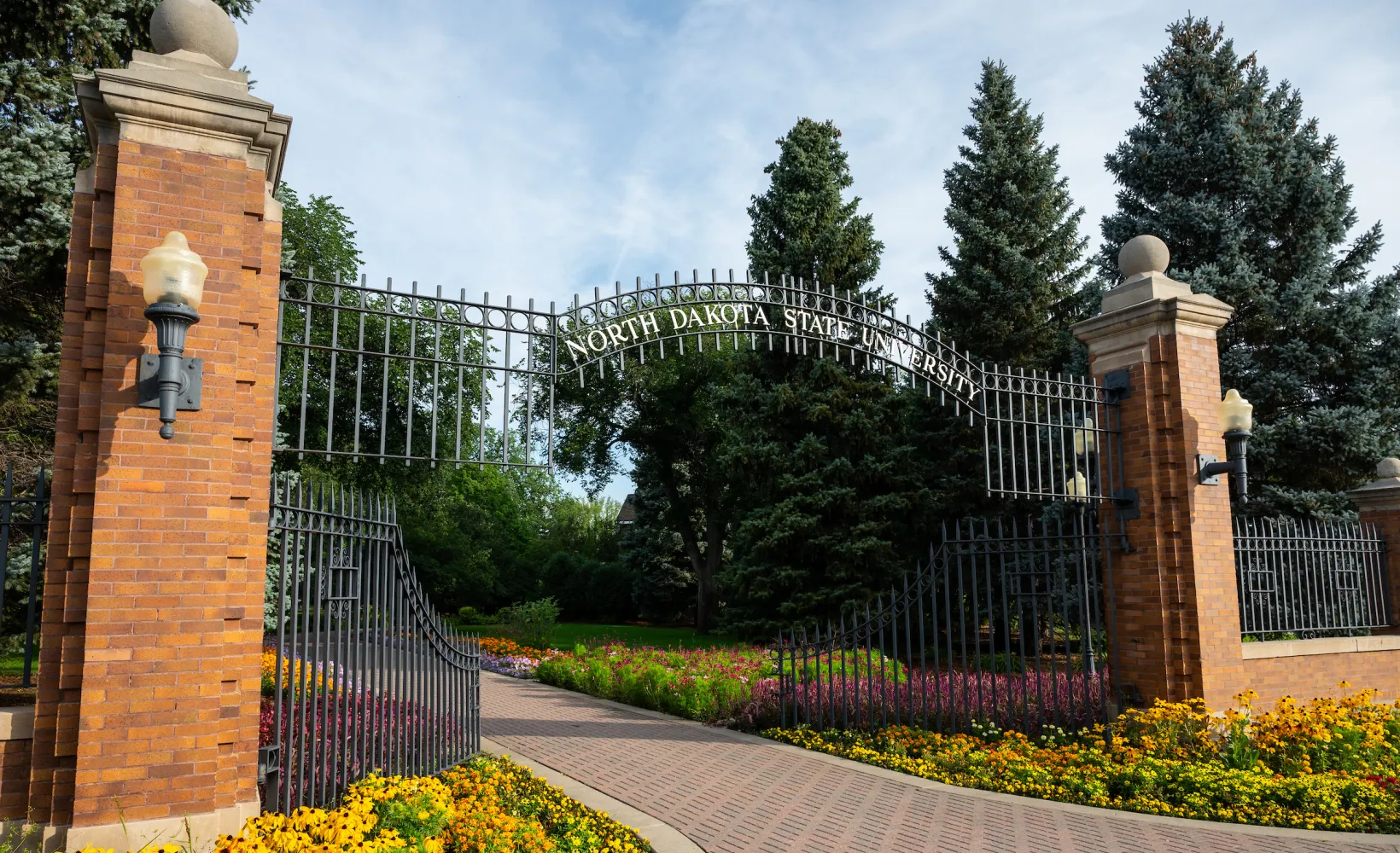 View of NDSU East Entrance Gate with blooming flowers