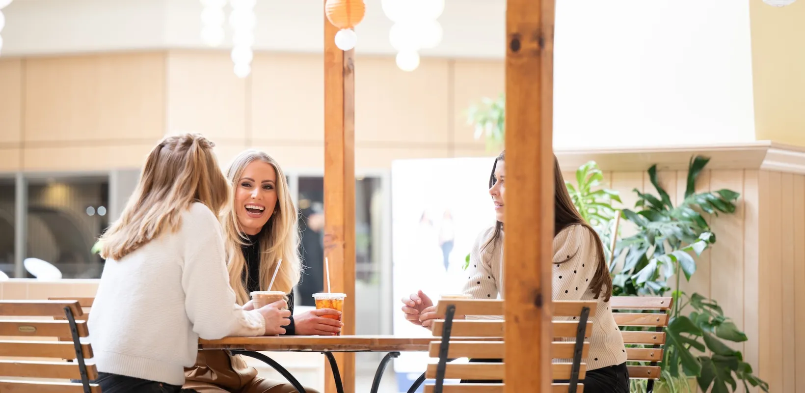 three women talking around a table