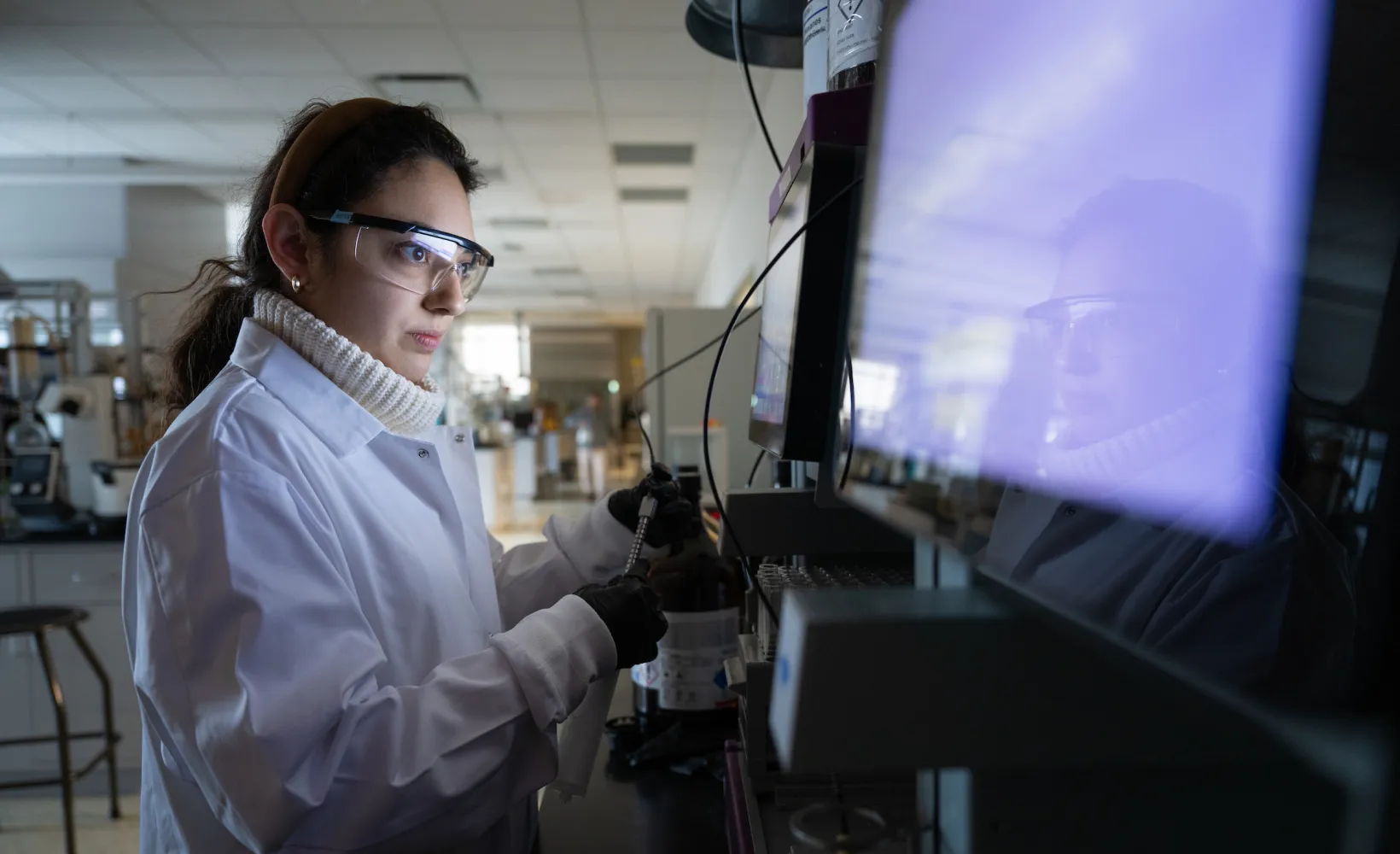 student performing a test in a lab