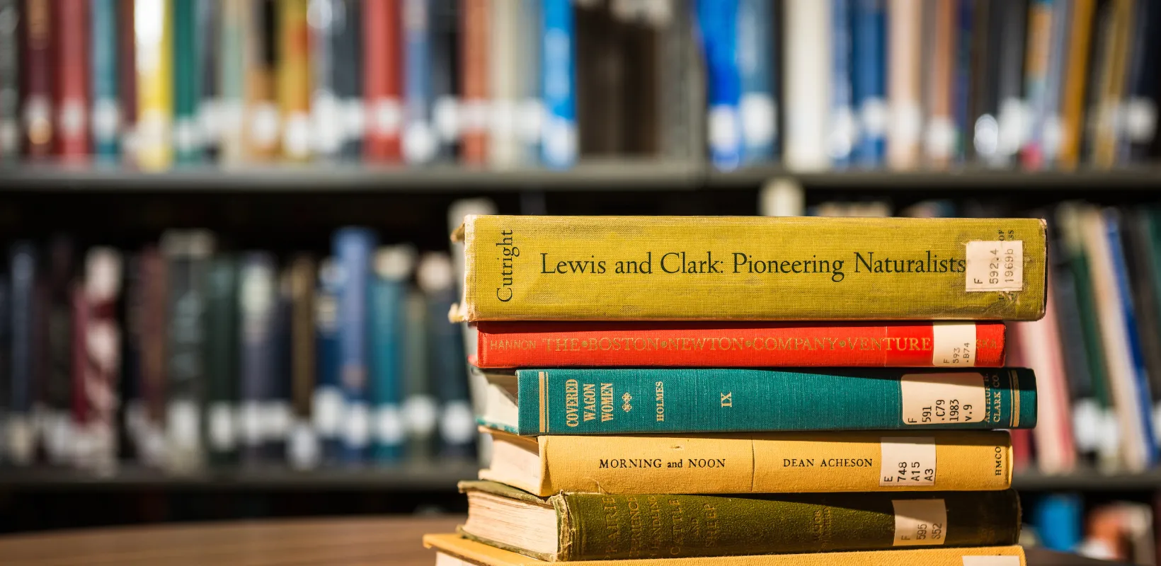 books sitting on a table in the library