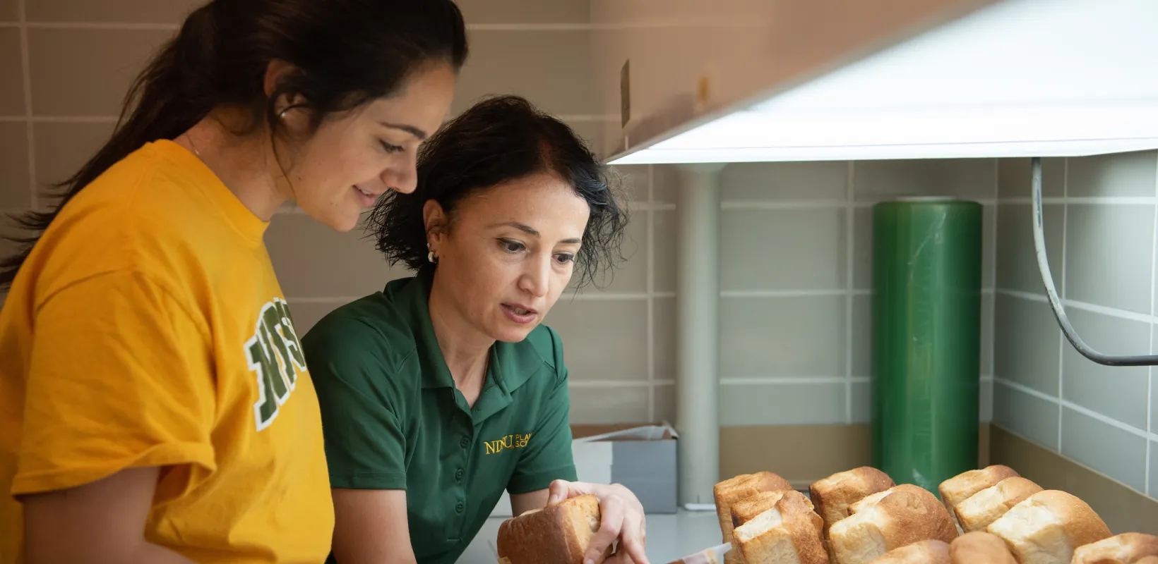professor showing a student freshly baked bread