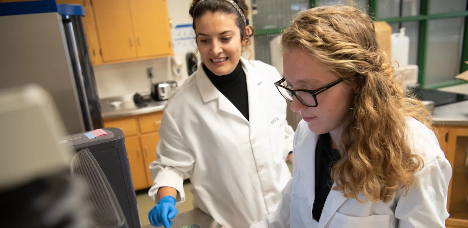 students looking at a computer in a lab