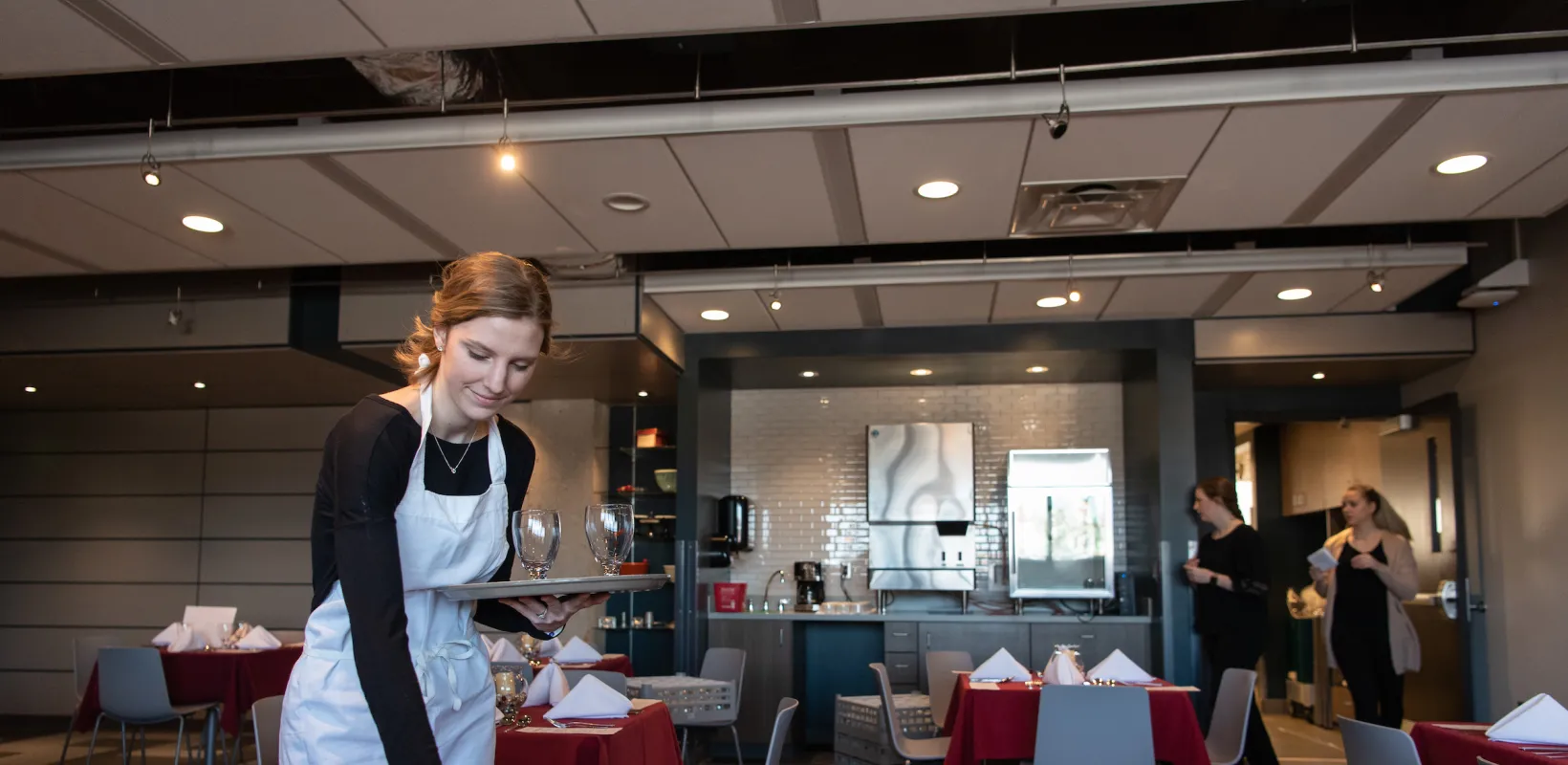server adding a place setting to a table