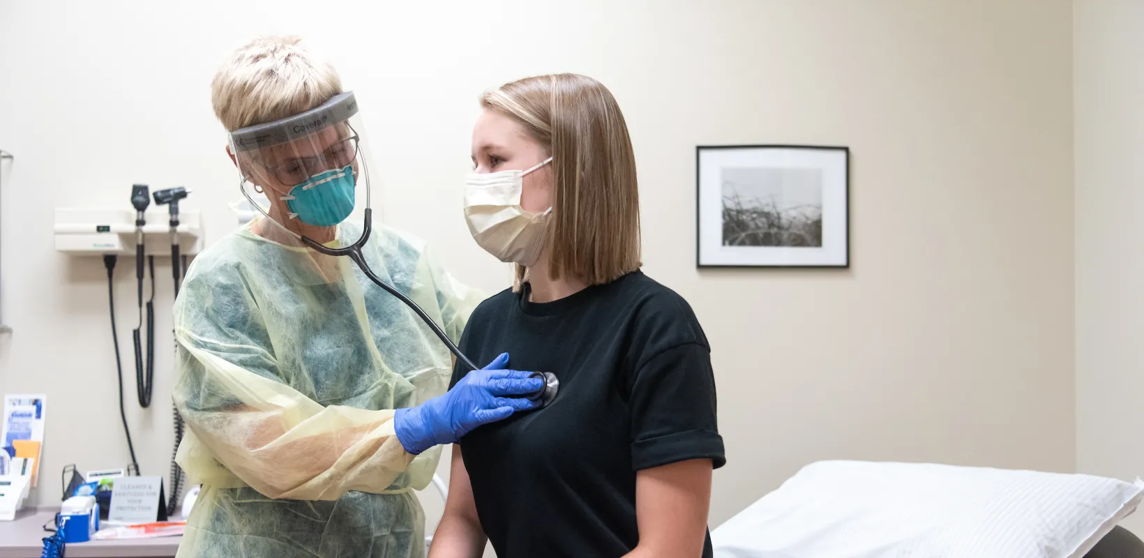 doctor with a patient in an exam room