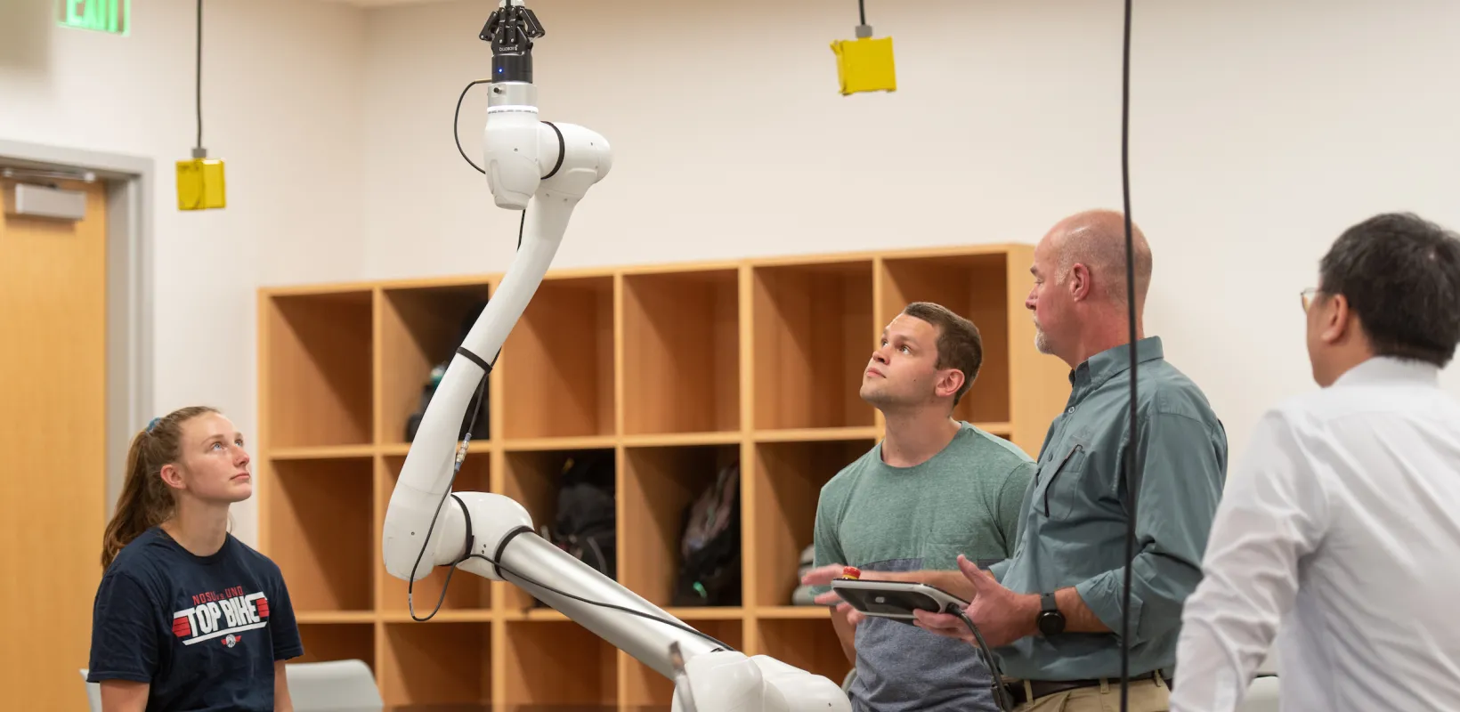 students working with a robot in a lab