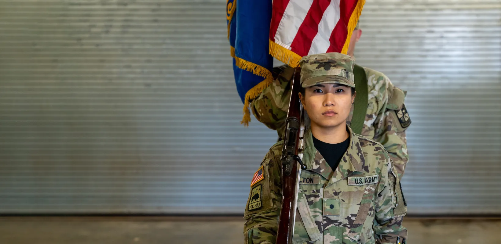 student dressed in military uniform standing at attention