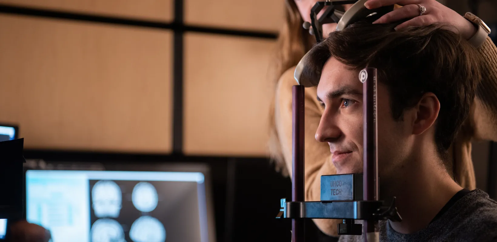 student taking measurements of a human head