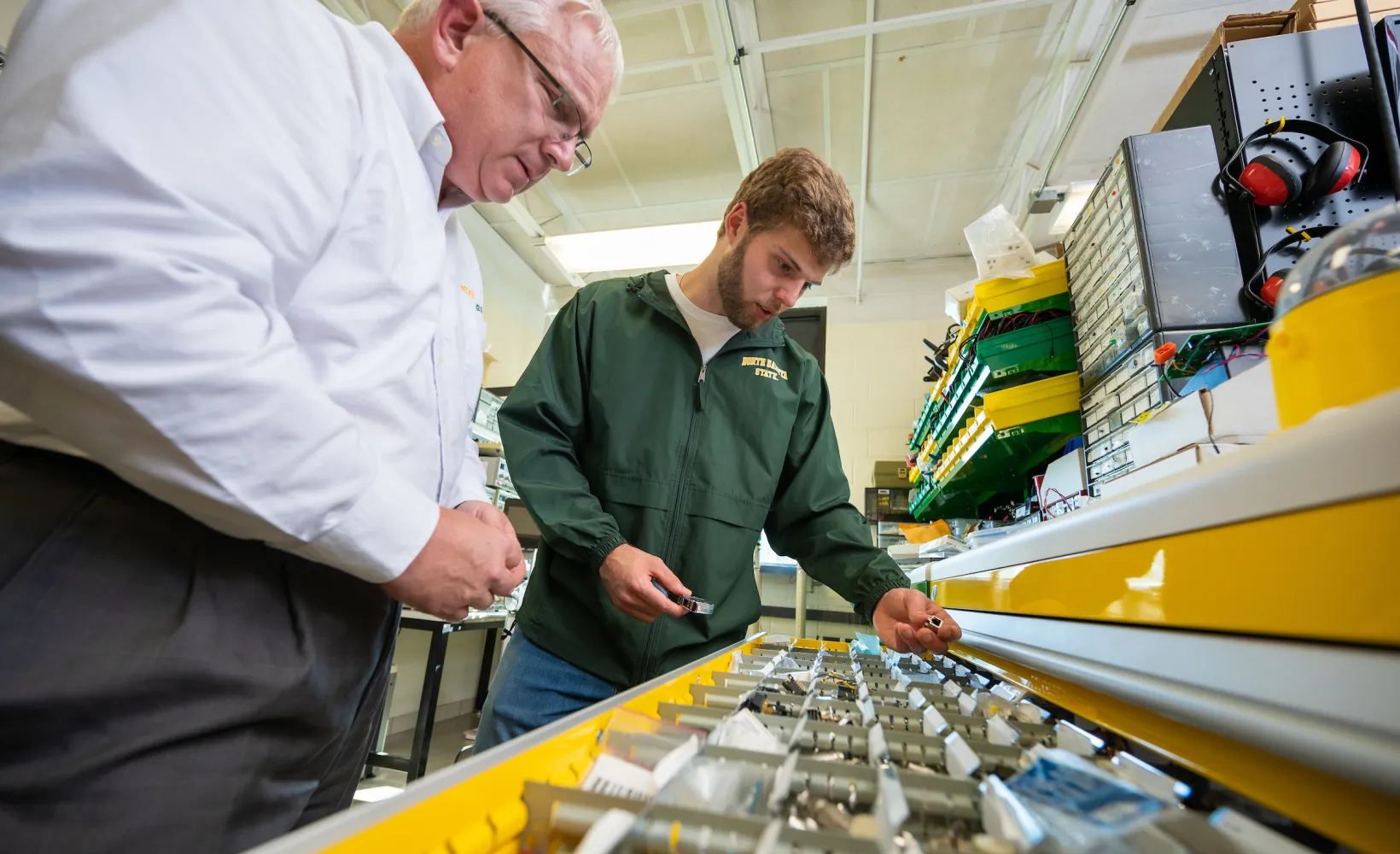 student and professor testing computer parts