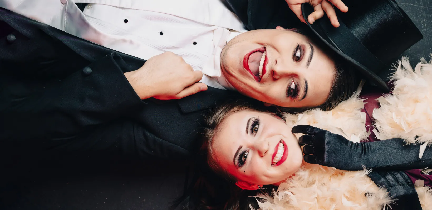 actors dressed in tuxedos smiling for the camera